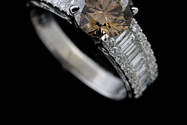 18K White Gold Fancy Brown Diamond Engagement Ringhttp://www.orospot.com/product/ruryymh/18k-white-gold-fancy-brown-diamond-engagement-ring.aspxSKU: RURYYMH$9,750.00This engagement ring is set with fancy brown round brilliant center diamond (2.04CT) and 52 sides diamonds (round diamonds and baguettes 1.15Cttw) Ring is made of 18k White Gold and is available in all sizes, please contact us for more information.