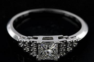 18K White Gold Princess Cut Antique Style Diamond Engagement Ringhttp://www.orospot.com/product/rbuyymh/18k-white-gold-princess-cut-antique-style-diamond-engagement-ring.aspxSKU: RBUYYMH$2,399.00This vintage style engagement ring is made of 18K white gold. Contains princess cut diamond center stone (.52cttw, G color and VS1 clarity) and twelve round cut, small diamonds from both sides (.10cttw) This beautiful diamond ring is available in all sizes, please contact us for your size preference and for more information.