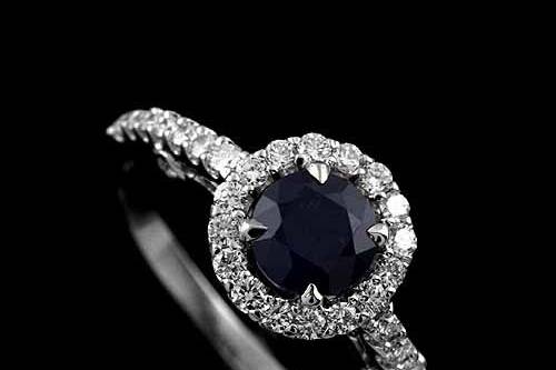 Cut Down Micro Pave Diamond Sapphire Halo Engagement Ring 18K White Goldhttp://www.orospot.com/product/r1024ven/cut-down-micro-pave-diamond-sapphire-halo-engagement-ring-18k-white-gold.aspxSKU: R1024VEN$1,699.00This beautiful engagement ring is made of 18k white gold. Ring contains round cut, sapphire center stone (1ctww.) and round cut diamonds (.53cttw, G-SI2 quality) set all around center stone and half way on the shank. This modern style ring is available in all sizes, please contact us for more information.
