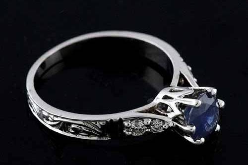 Prong Set Diamonds Blue Sapphire Art Deco Reproduction Engraved Engagement Ringhttp://www.orospot.com/product/r2036ven/prong-set-diamonds-blue-sapphire-art-deco-reproduction-engraved-engagement-ring.aspxSKU: R2036VEN$679.00This Art Deco style engagement ring is a 14k white gold pieces. There are four diamonds (0.10cttw G-SI1 quality) prong set on the both side of the shank. Ring contains 6 mm (Approx 1ct) blue sapphire center stone, securely set in a six prongs. Shank is beautifully engraved 3/4 way down. Ring Dimension: Center stone set above the finger: 6.7 mm Bottom Shank Width: 1.8 mm Bottom Shank Height: 1 mm Top Shank Width: 3 mm Top Shank Height: 1.5 mm Ring Weight ( in a size 6 - 2.7 g)