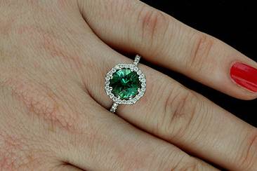 14k White Gold Pave Burnish Set Diamond Cabochon Green Tourmaline Art Deco Style Engagement Ringhttp://www.orospot.com/product/r1099ven/14k-white-gold-pave-burnish-set-diamond-cabochon-green-tourmaline-art-deco-style-engagement-ring.aspxSKU: R1099VEN$1,439.00This design, art deco style engagement ring is made of 14k white gold. Ring is securely set with 41 round diamonds (.39cttw, G-VS quality).There are diamonds all around center stone, pave and burnish set on the basket and six of them on the shank. Ring contains round cabochon green tourmaline center stone (7.5 mm approx. 1.80ct). Width of the shank is 2 mm, height 1.6 mm, center stone is set above the finger 9 mm. Ring was designed to accommodate 7.5 mm center stone and is also available in variety of other gemstones. Please contact us if you are interested in any of these options. Please allow 1-2 weeks to complete the order.
