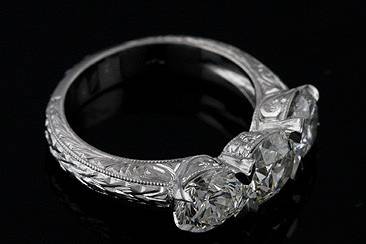 3ct PLatinum Hand Engraved Engagement Ring Mountinghttp://www.orospot.com/product/r1034ven/3ct-platinum-hand-engraved-engagement-ring-mounting.aspxSKU: R1034VEN$1,999.00This vintage style engagement ring contains 3 – 1ct round diamonds which are v-prong set. The shank is hand engrave and milgrained. The price of this ring doesn’t include center stones. (Stones can be ordered from our website, for more detail contact us or visit our diamond inventory)