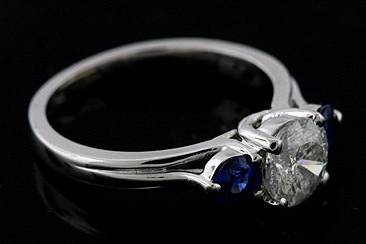 14K White Gold Diamond and Blue Sapphire Modern Style Engagement Ring Mountinghttp://www.orospot.com/product/rmh6/14k-white-gold-diamond-and-blue-sapphire-modern-style-engagement-ring-mounting.aspxSKU: RMH6$1,199.00This modern design engagement ring was pictured with two round sapphires (.51cttw) and one round brilliant diamond (1.23ct). The center stone is not included with the price, but can be ordered separately (please contact us for more information or browse our diamond inventory). Beautiful ring mounting is available in all sizes. please contact us for your size preference.