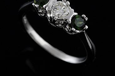 Vintage Inspired 14K White Gold 3 Stone Diamond Green Tourmaline Engagement Ringhttp://www.orospot.com/product/aa9680ma/vintage-inspired-14k-white-gold-3-stone-diamond-green-tourmaline-engagement-ring.aspxSKU: AA9680MA $930.00This vintage style 3 stone 14k white gold engagement ring has 3 round stones: 1 diamond- approx. .30Ct, H color and SI2 clarity and 2 green round pink tourmaline's on the sides .40cttw. All three stones are set in prongs and half bezels. This ring can be ordered with any other combination of diamonds and color stones. Please contact us for more details.
