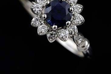 18kYellow Gold Diamond Sapphire Flower Modern Engagement Ringhttp://www.orospot.com/product/r2003ven18k/18kyellow-gold-diamond-sapphire-flower-modern-engagement-ring.aspxSKU: R2003VEN18K$1,209.00This beautiful halo, flower engagement ring is made of 18k yellow gold. Ring contains round, prong set, diamond cut sapphire center stone (5 mm, approx .50ct.). There are diamonds (.34cttw, G-VS quality) prong set all around gem and four of them pave set on the shank. Center stone is set above the finger 6 mm, shank is 1.3 mm tall and 2 mm wide. Ring was designed to accommodate 5 mm center stone and is also available in variety of other gemstones. Please contact us if you are interested in any of these options. Laser Engraving: 