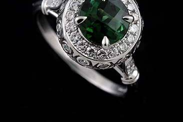14k White Gold Pave Burnish Set Diamond Cabochon Green Tourmaline Art Deco Style Engagement Ringhttp://www.orospot.com/product/r1099ven/14k-white-gold-pave-burnish-set-diamond-cabochon-green-tourmaline-art-deco-style-engagement-ring.aspxSKU: R1099VEN$1,439.00This design, art deco style engagement ring is made of 14k white gold. Ring is securely set with 41 round diamonds (.39cttw, G-VS quality).There are diamonds all around center stone, pave and burnish set on the basket and six of them on the shank. Ring contains round cabochon green tourmaline center stone (7.5 mm approx. 1.80ct). Width of the shank is 2 mm, height 1.6 mm, center stone is set above the finger 9 mm. Ring was designed to accommodate 7.5 mm center stone and is also available in variety of other gemstones. Please contact us if you are interested in any of these options. Please allow 1-2 weeks to complete the order.
