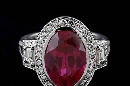 18K White Gold Oval Bezel Pink Tourmaline Pave Diamond Halo Engagement Ring Mounting Settinghttp://www.orospot.com/product/r2039ven/18k-white-gold-oval-bezel-pink-tourmaline-pave-diamond-halo-engagement-ring-mounting-setting.aspxSKU: R2039VEN $2,739.00This fancy engagement ring was designed by Eternal and is a 18k white gold pieces. Center stone and sides trapezoid diamonds are NOT included with the price, but can be ordered separately from our inventory. Pictured with 5ct (14 x 10) oval pink tourmaline and two sides diamonds trapezoid .30cttw. Ring can be create to accommodate any shape/size of the center stone. Mounting contains round diamonds, micro pave set around center stone (.38ct, G-VS quality), 3/4 way on the split shank (.33ct, G-VS quality) and around sides trapezoid stones (.14cttw, G-VS quality). Top of the ring is 19.5 mm x 15 mm, please note that the width depend on the size of the center stone. Bottom shank is 3 mm wide and 1.5 mm tall.