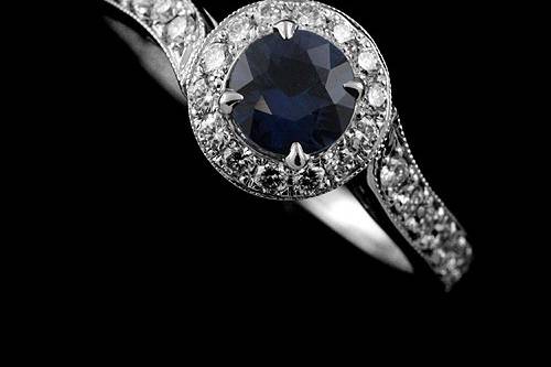 Blue Round Sapphire Asymmetrical Micro Pave Diamonds Engagement Ring 14K White Goldhttp://www.orospot.com/product/r1020wpps/blue-round-sapphire-asymmetrical-micro-pave-diamonds-engagement-ring-14k-white-gold.aspxSKU: R1020WPPS$1,449.00This unique engagement ring is 14k white gold pieces. Contains round cut, prong set blue sapphire ( 5mm approx .60cttw) and diamonds (.28cttw, G-SI1 quality), pave set all around center stone and half way on asymmetrical the shank. Center stone is set above the finger approx 6 mm. Width of the bottom is 1.6 mm, at the top (diamond section) 2.6 mm. Height on the bottom is 1.5 mm, at the top 2.7 mm. Top of the ring is 8 mm in diameter. Ring is available in all finger sizes, please allow 2-3 weeks to complete the order.