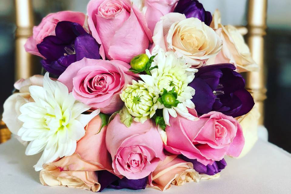 Blush roses, cream dahlias, purple anemones, champagne roses