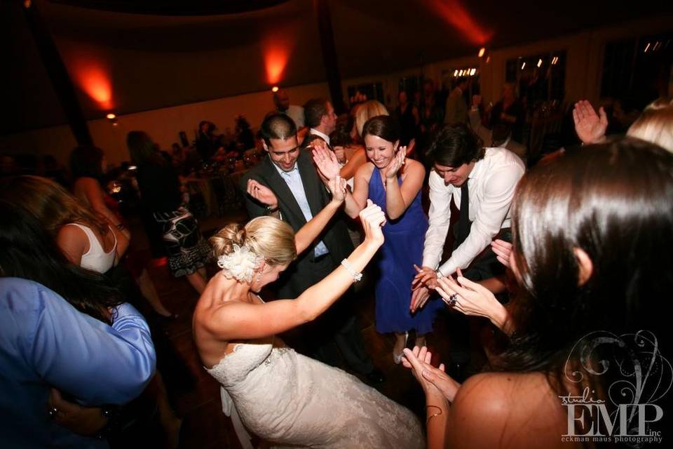 Newlyweds dancing with guests