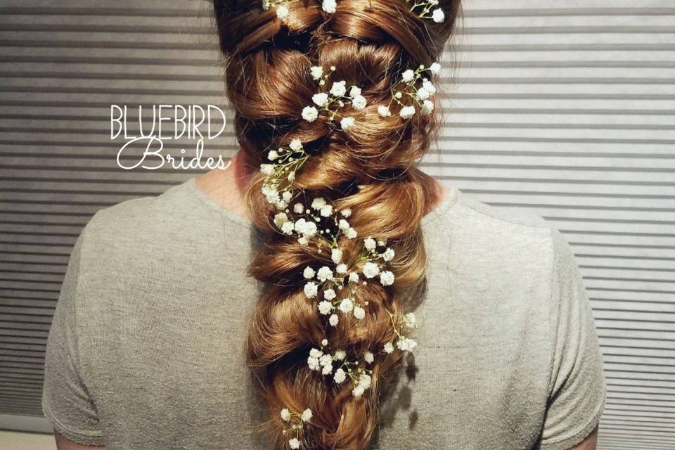 Flowers tucked into a thick braid