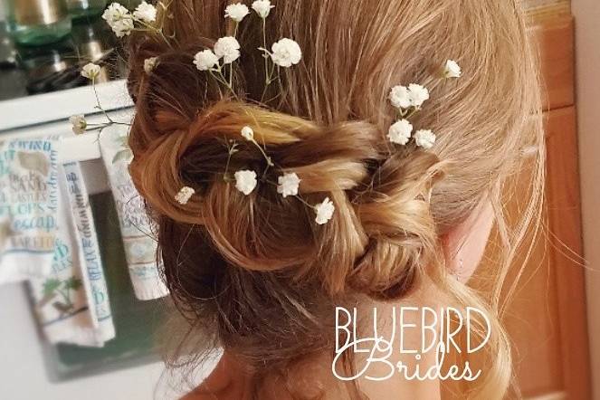 Baby's breath flowers tucked into a braid