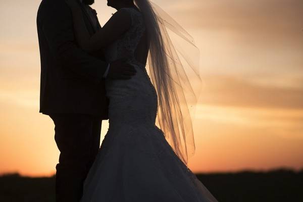 Holding each other at sunset