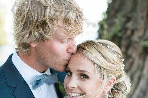 Groom kissing his bride