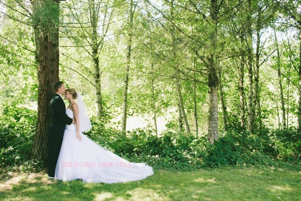 This soft finger tip veil accents the brides tulle dress.  It also has a blinged out comb to attach into hair style.