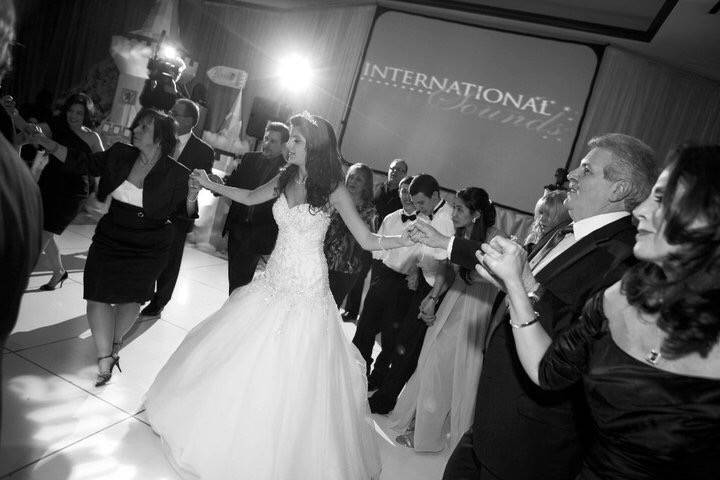 Bride leads party into a  traditional Greek dance