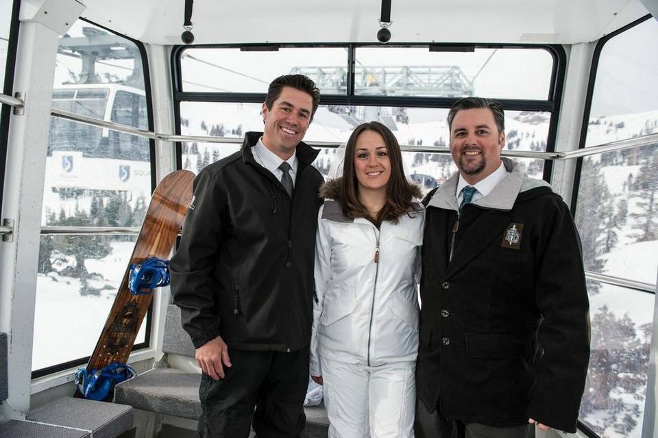 Newlyweds and officiant on the cable car