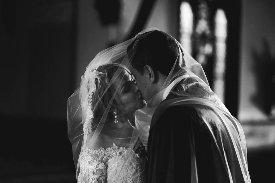 Couple kissing under veil