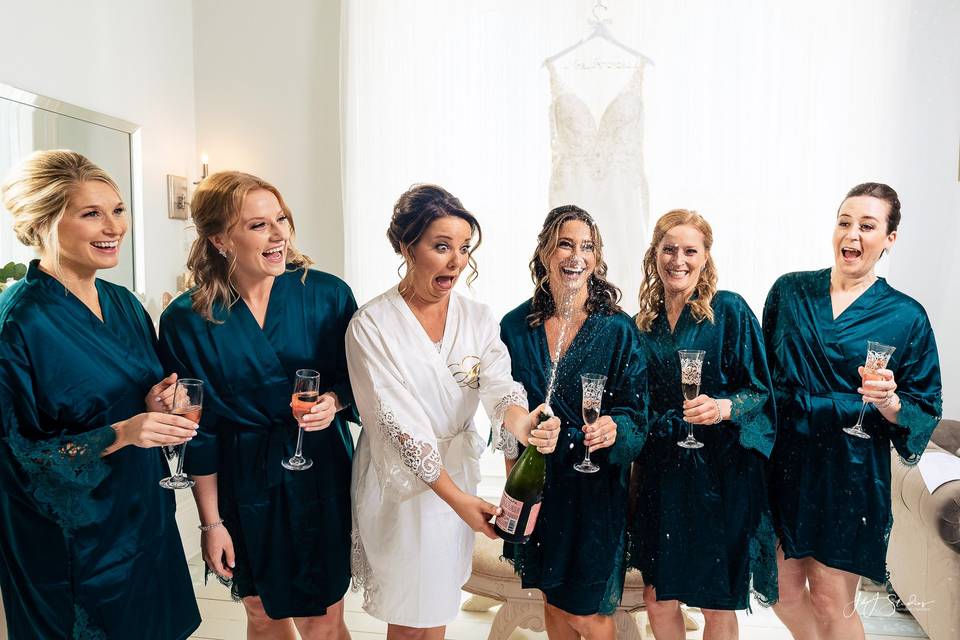 Bridesmaids Popping Champagne