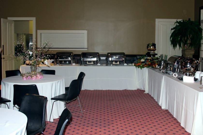 A view of the food buffet table.  Food Items included:   Brisket, Rice Dressing, Fried Fish, Vegetable/Fruit/Cheese Tray, Crawfish & Spinach Dip, Spinach & Artichoke Dip, Chicken Fettuccini and Corn & Crab Bisque.   The wedding event was located at Rip Van Winkle Gardens, New Iberia, LA.