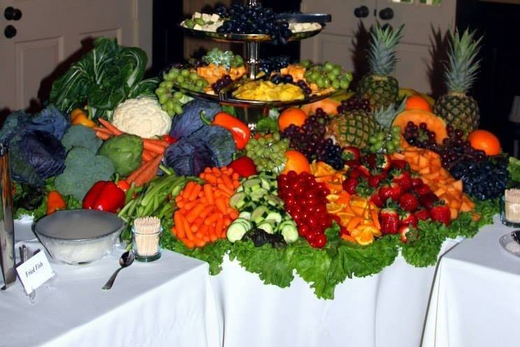 Our beautiful Vegetable, Fruit and Cheese Selection.     We used whole fruits and vegetables to decorate the table and then added the sliced fruit and vegetables in front.   We placed the cheese with grapes on the 4 tier tray.   This was our main focal point of the buffet table.