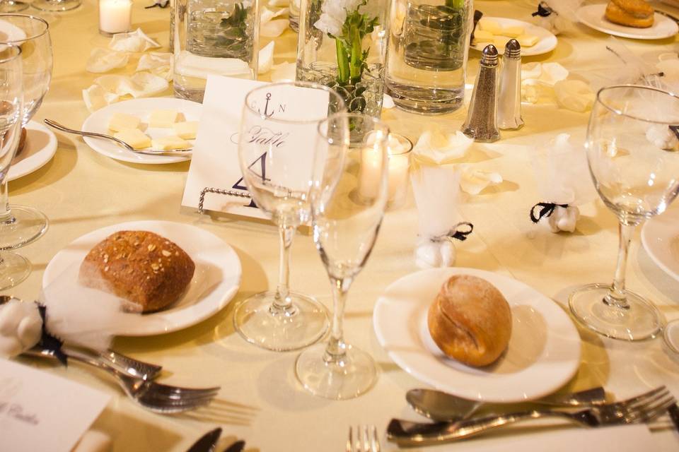 Staggered heights cylinder vases filled with white callas , snap dragons , and dendrobium orchids .