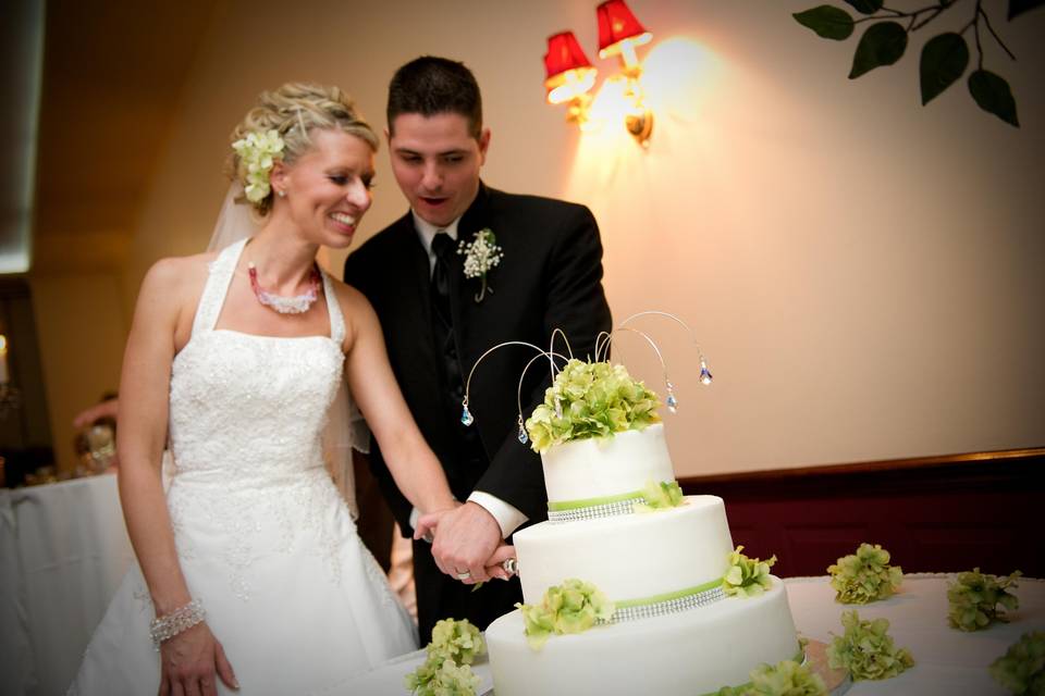 Couple cut a 3 layered wedding cake