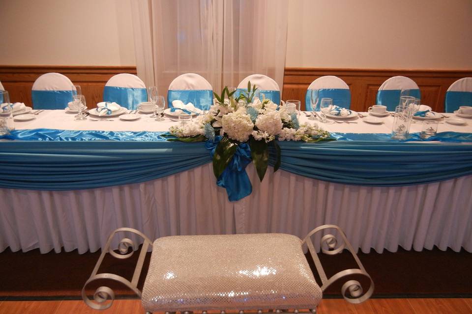 Long head table with floral centerpiece