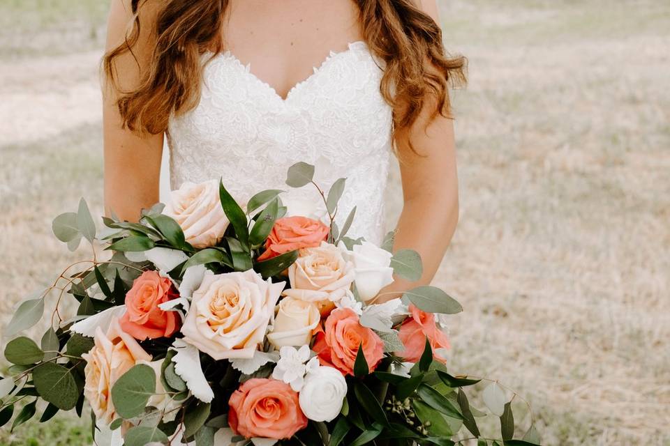 Bride posing with a fresh bouquet of flowers