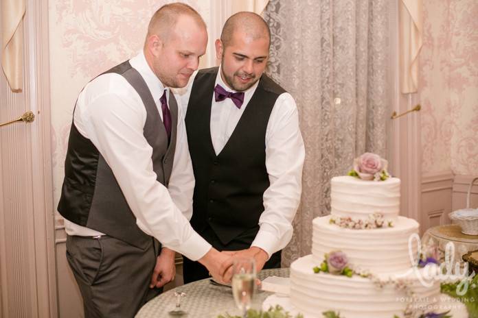 Couple slicing their wedding cake