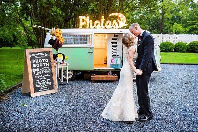 Newlyweds kiss by the minibus booth