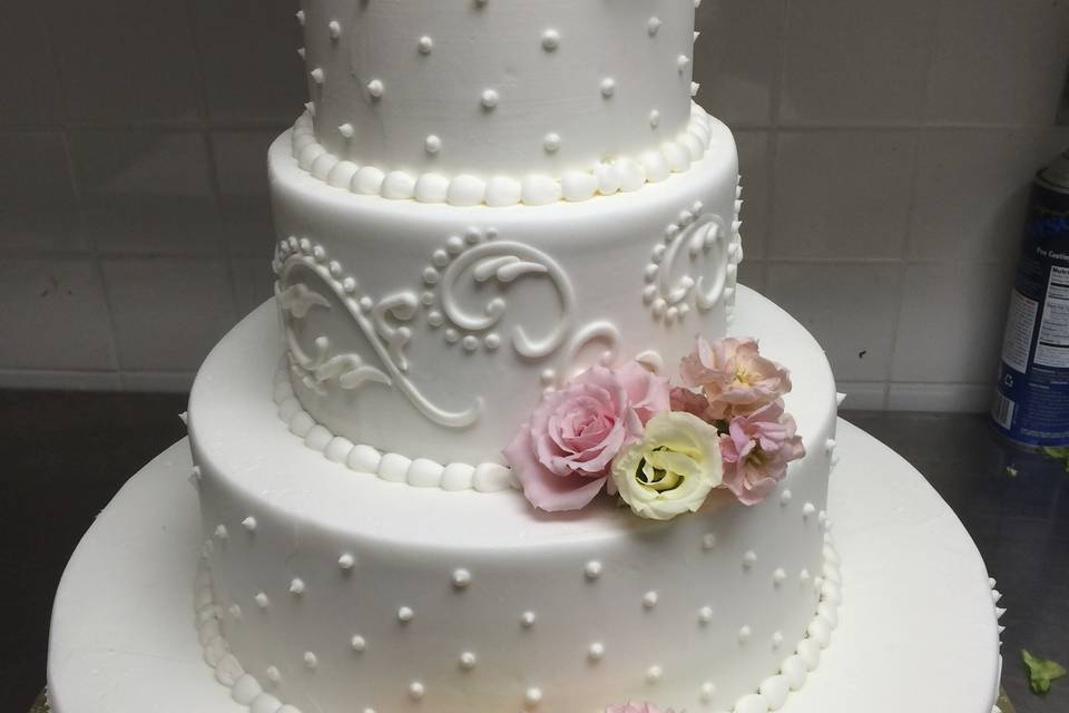 White wedding cake with pastel flowers