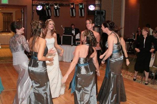 The bride with her bridesmaids dancing