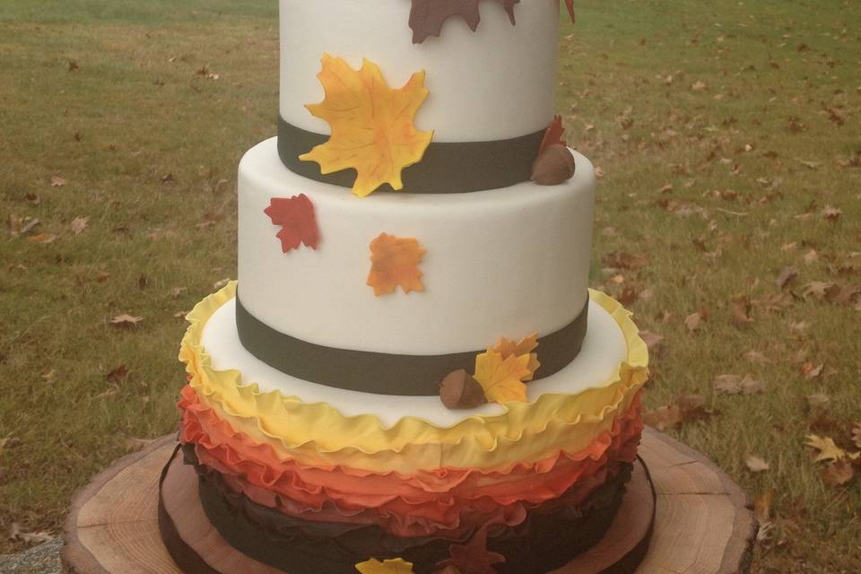 Autumn Ruffles wedding cake presented on a chunky wood base.  Pictured cake is covered in fondant but would be just as pretty in a buttercream finish.  Wood base available for rent.