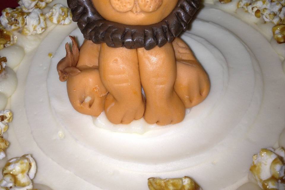 Leo the Lion cake topper surrounded by homemade caramel corn.