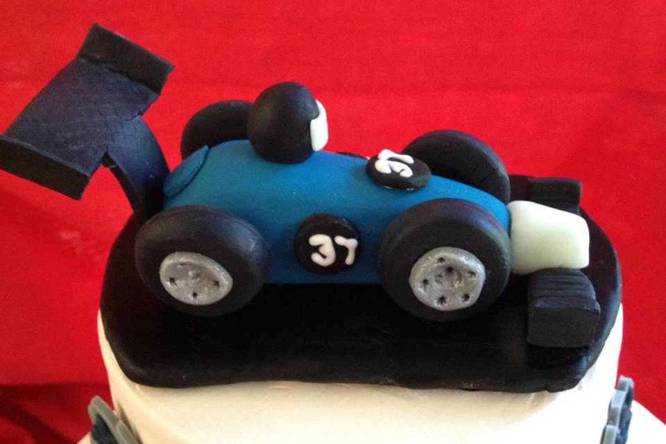 Close up of race car on UNH graduation cake.