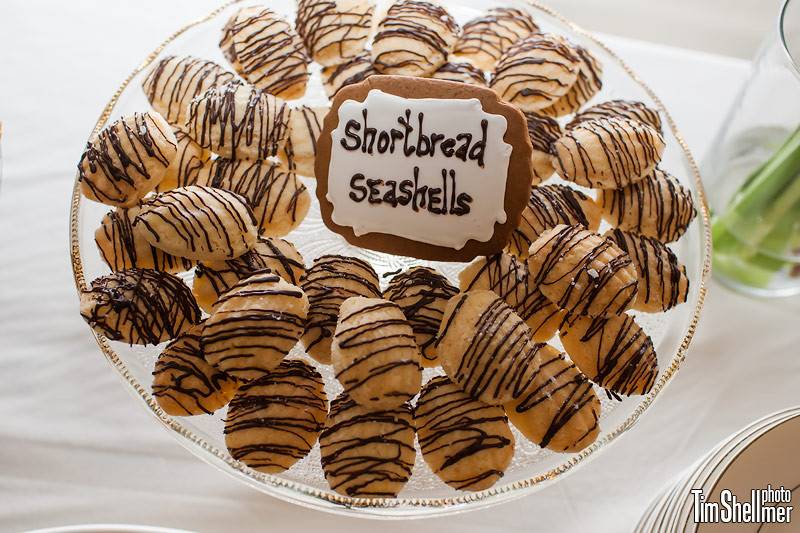 Shortbread seashells drizzled with dark chocolate, garnished with flecks of sea salt.