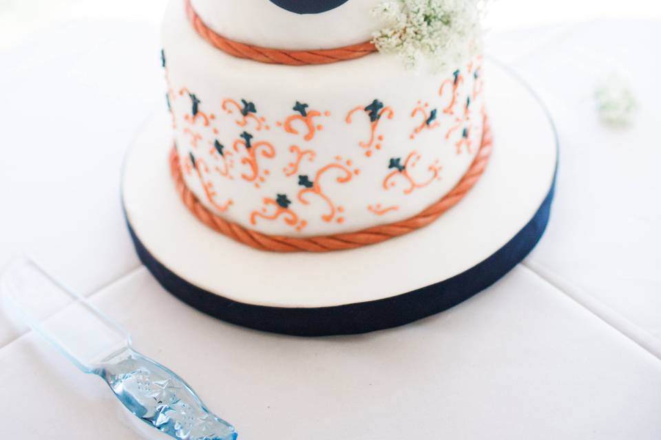 Darling little nautical cake featuring fondant roping and anchor medallions.