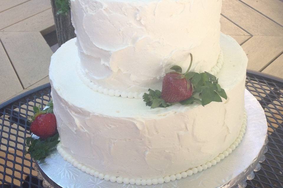 Chiffon cake filled with whipped cream and crushed strawberries.  Vanilla buttercream frosting.