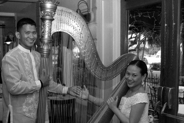 Newlyweds pose with the harp