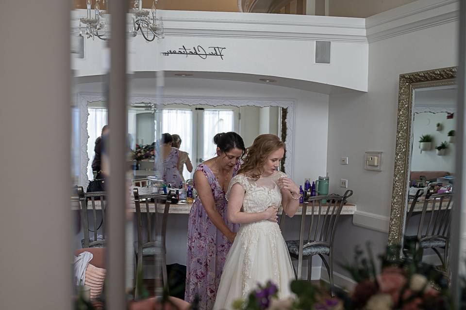 Mom helping daughter in dress