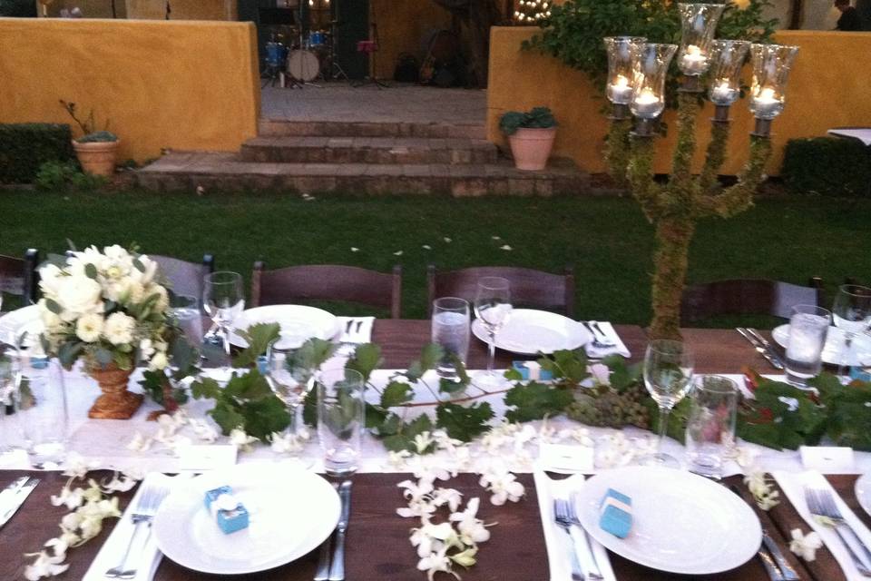 Wine country table with moss covered candelabras and grapevines