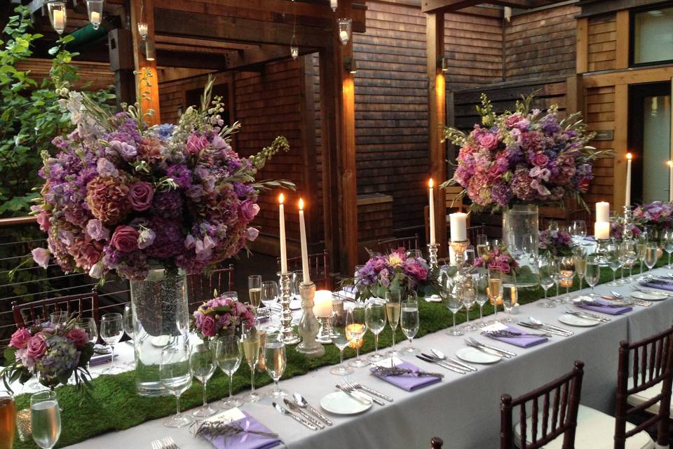 Hanging votives over a moss runner and large pave arrangements