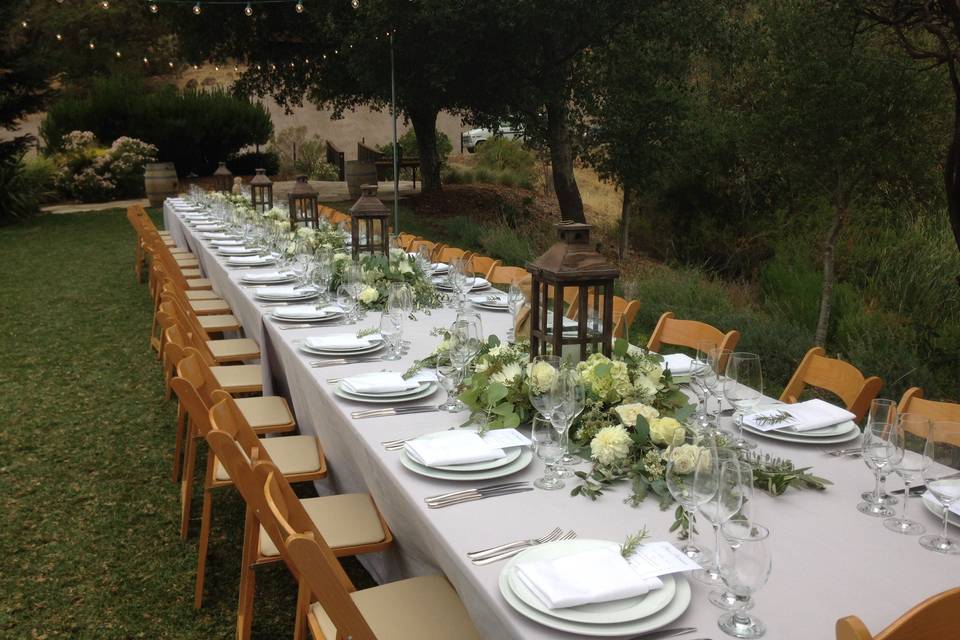 Calistoga Ranch long tables with lanterns tucked with florals