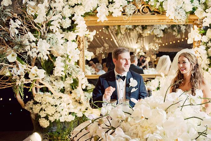 Gorgeous Bridal Table set for two, gilded mirror backdrop, adorned with sandblasted manzanita, Orchids