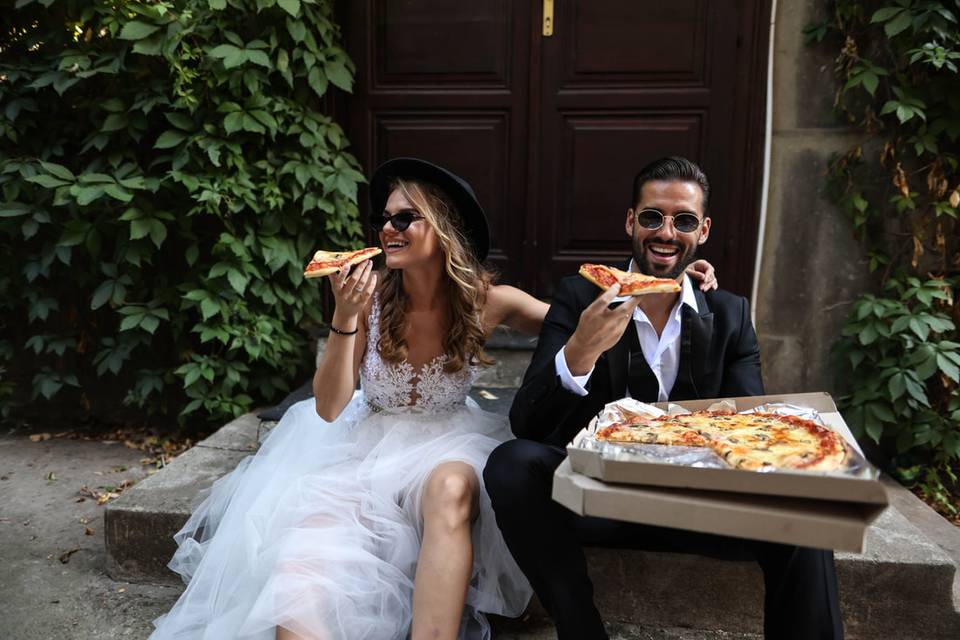 Enjoying wedding pizza