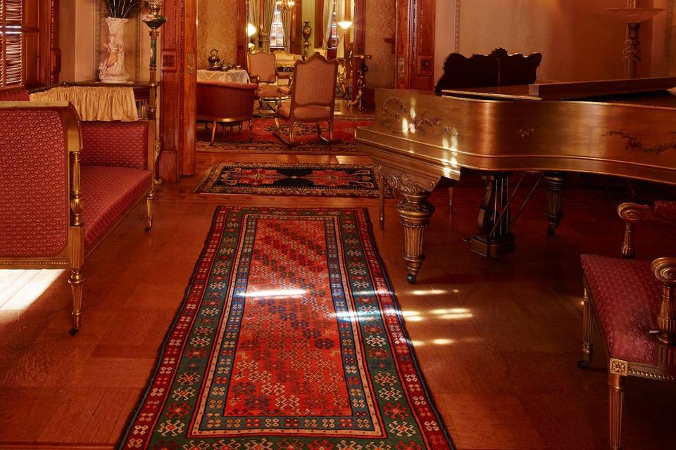 The open floor plan on the first floor of the museum allows visitors to view the music room, drawing room, and front parlor. The Heurich family's original 1901 Steinway is seen in the right foreground.Image courtesy Xang Photography