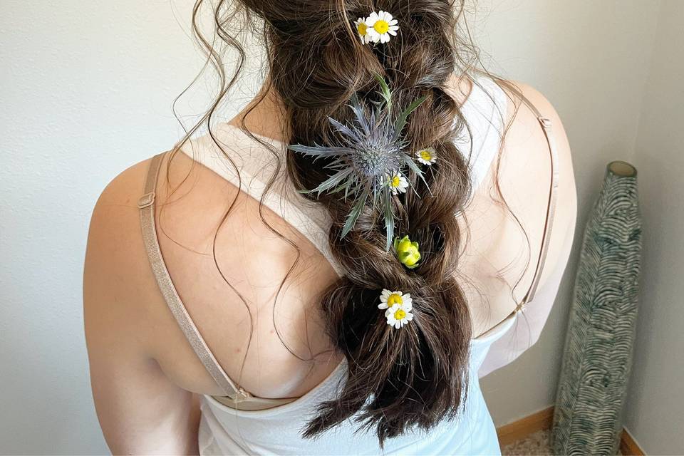Flowers in her braided hair