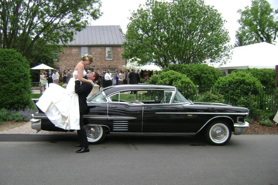 A classic snapshot in Leesburg Virginia, where both the groom and the Cadillac swept the bride off her feet