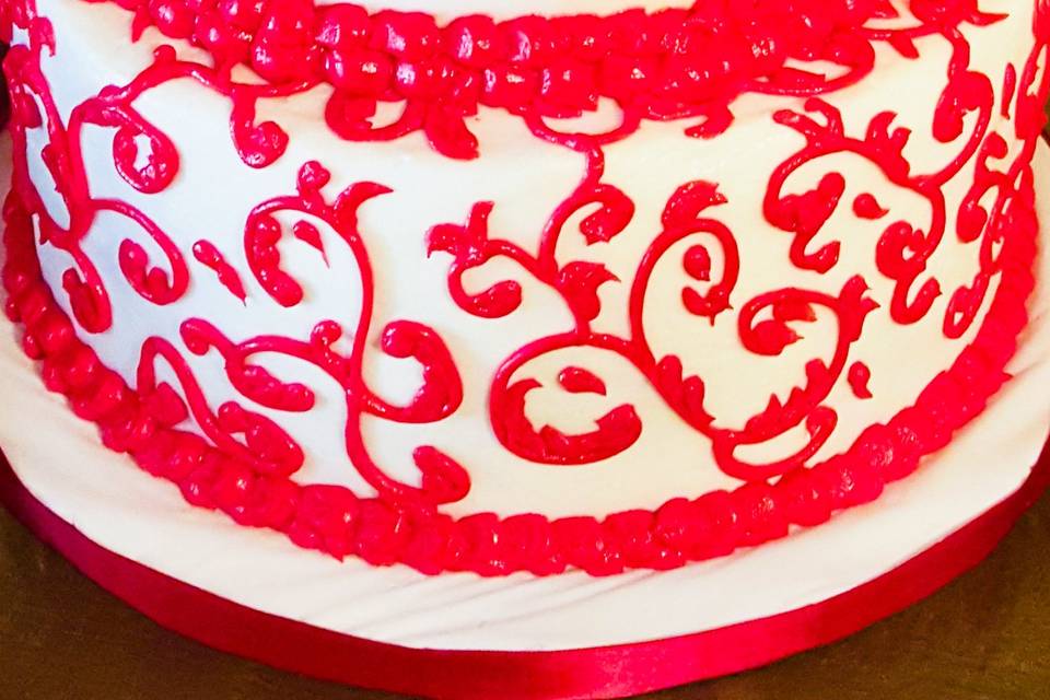 Red and white scrolls cake